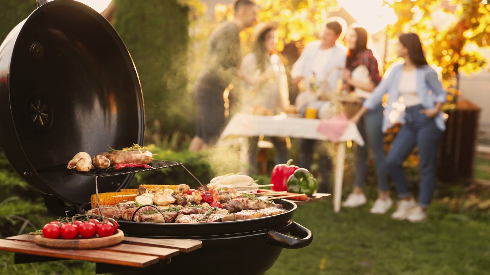 Group of Friends Having a BBQ Outdoors in Summer