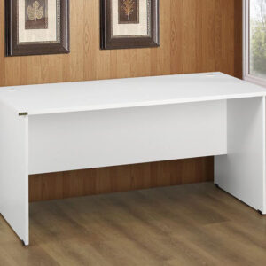 A SW2 1500 x 750 White Desk in a room setting in front of a brown wall that has two picture frames.
