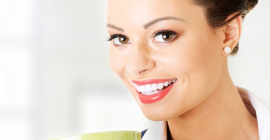 Smiling businesswoman having coffee break