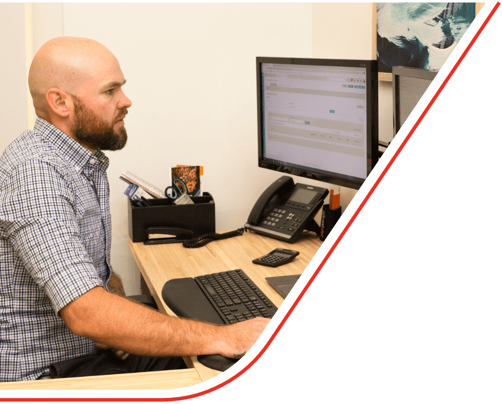 Mask Group 11 Heath working in front of laptop and monitors