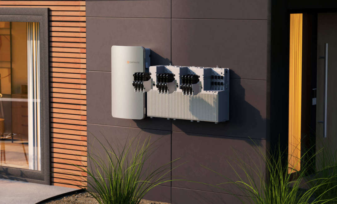 Enphase IQ solar storage batteries mounted on the exterior wall of a modern house