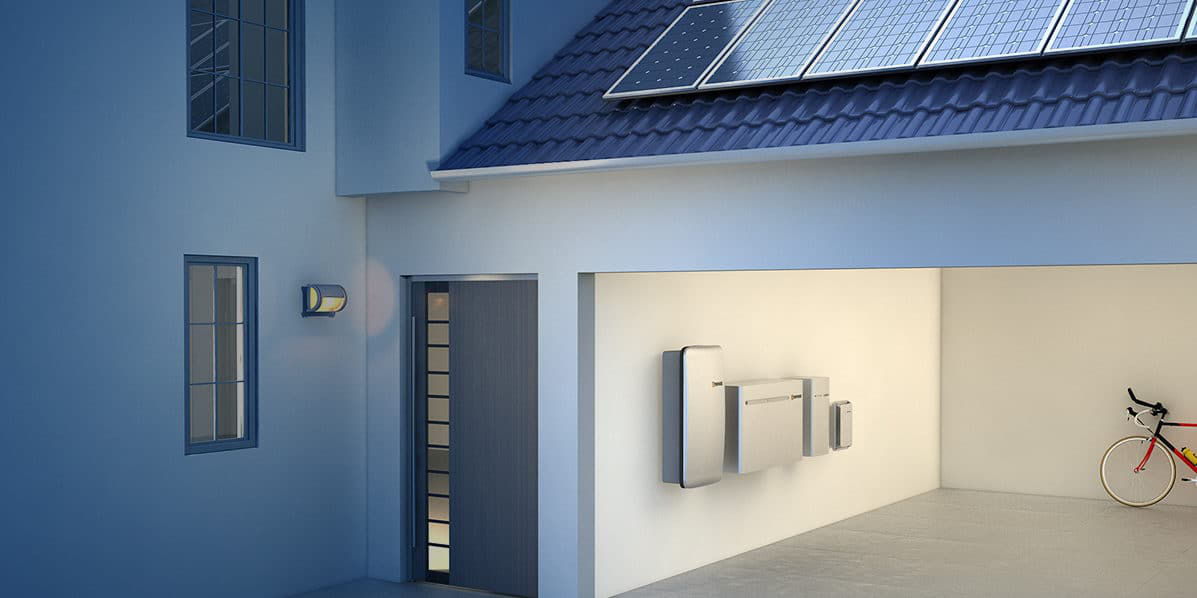 An Enphase Encharge battery storage system is mounted on the left side interior wall of a house's internal garage.