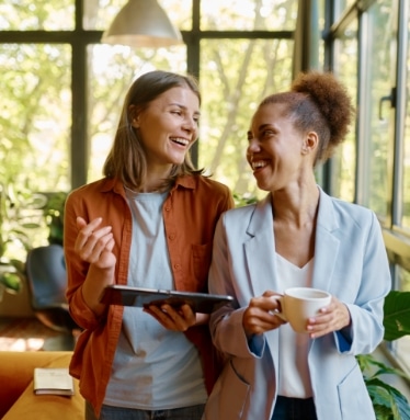 happy-cheerful-coworkers-chatting-at-workplace-2023-01-31-23-19-40-utc