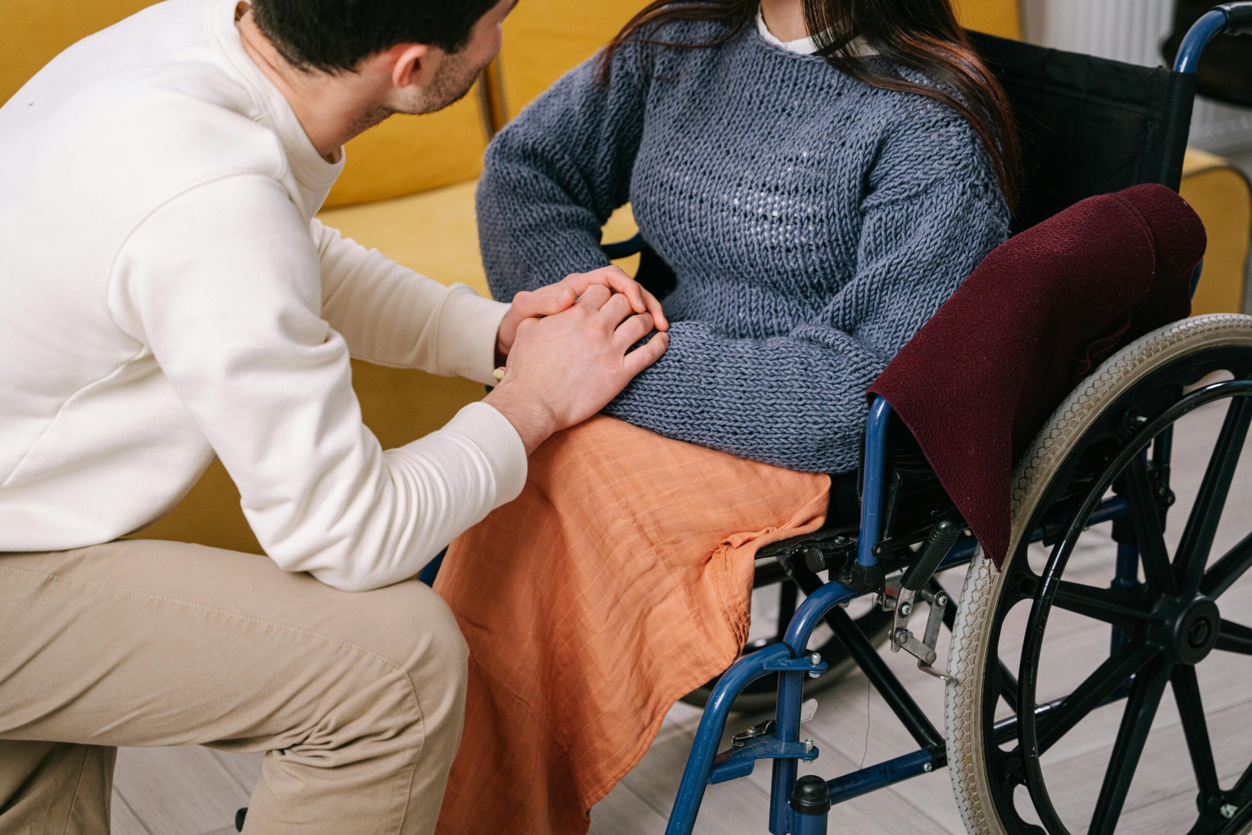 Man Holding Disabled Woman's Hands