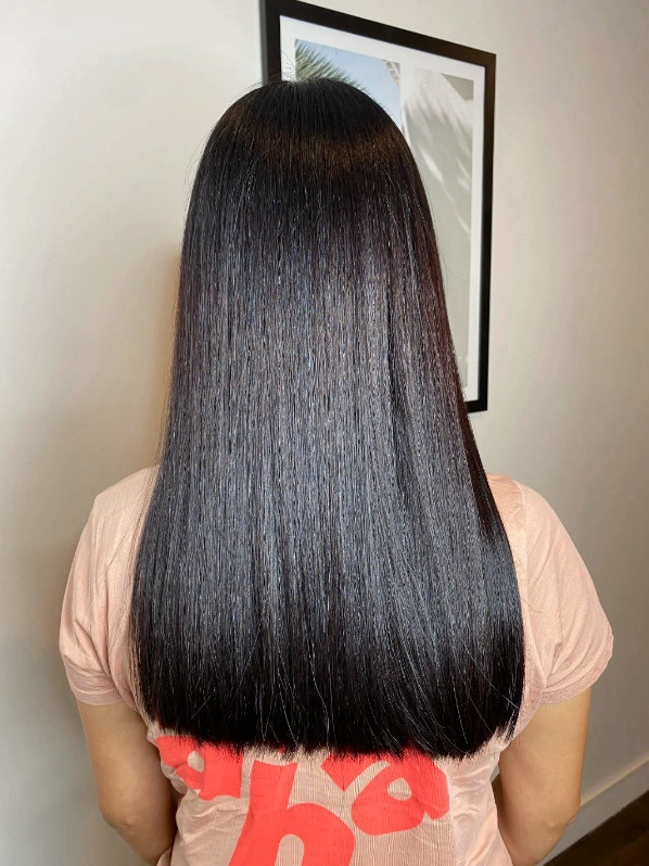 A rear image of a models beautiful long hair after Keratin Smoothing