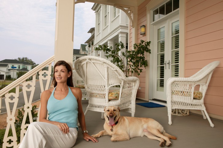 Young woman and her dog on their porch