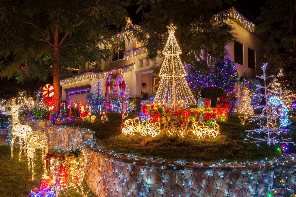 house and front yard with lots of christmas decorations and christmas lights | swoosh finance