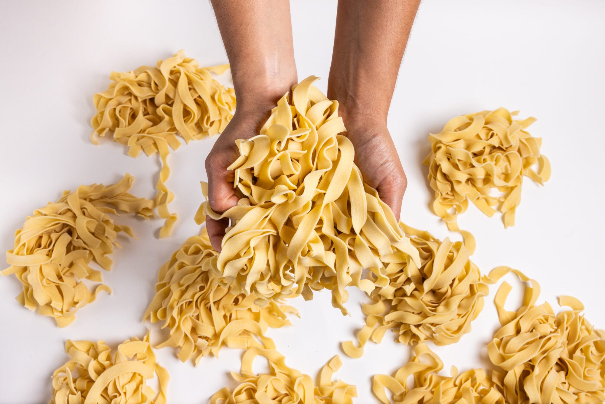 Hands holding pasta