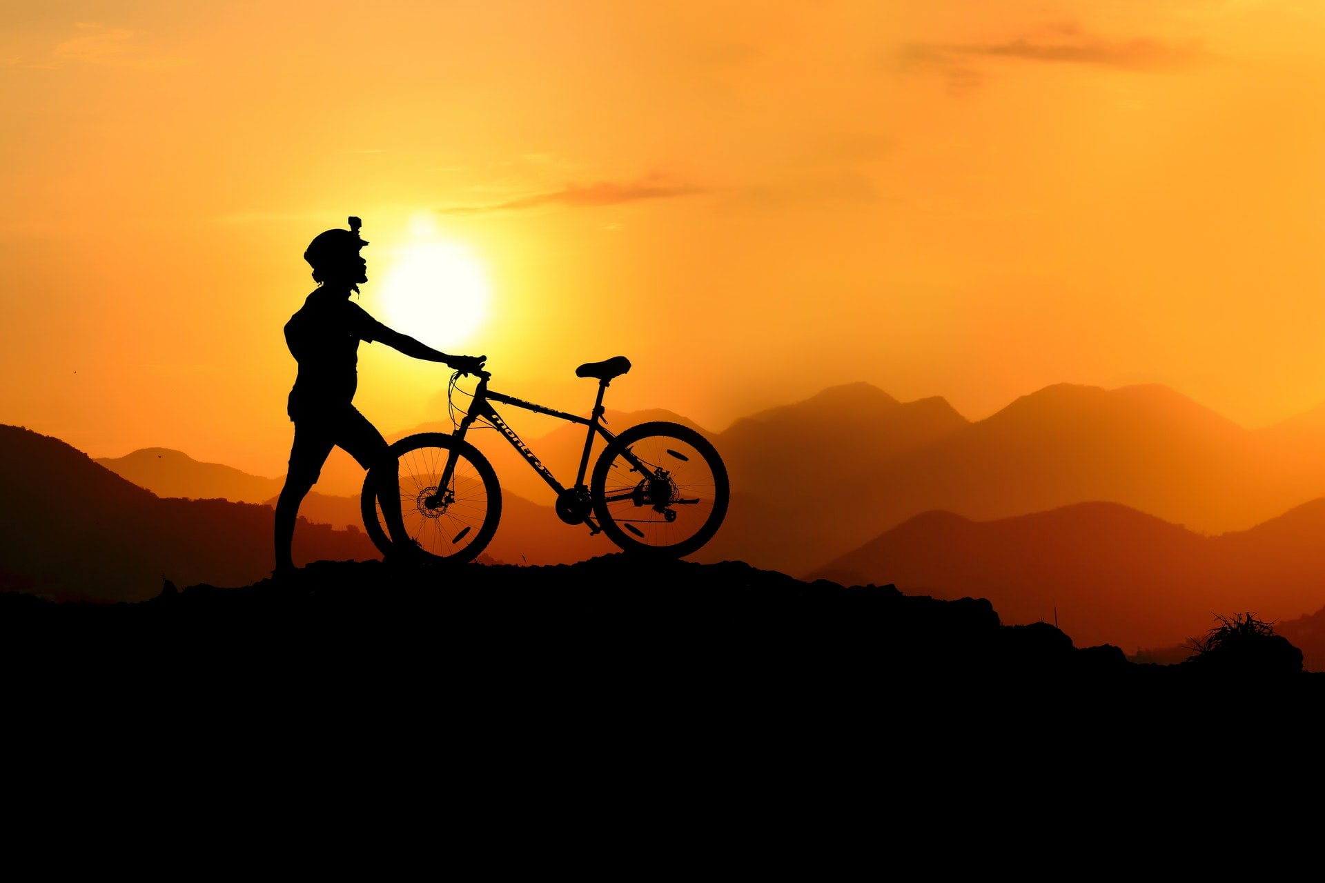 Bike rider on a hill at sunrise