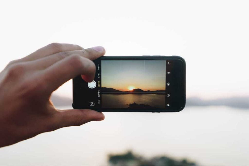 Image of a hand holding an iPhone to take a picture
