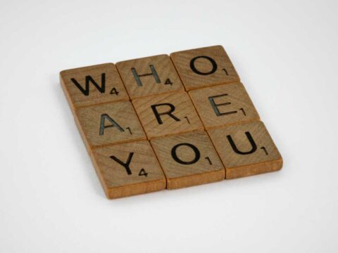 Image of scrabble blocks arranged in three rows to spell who are you