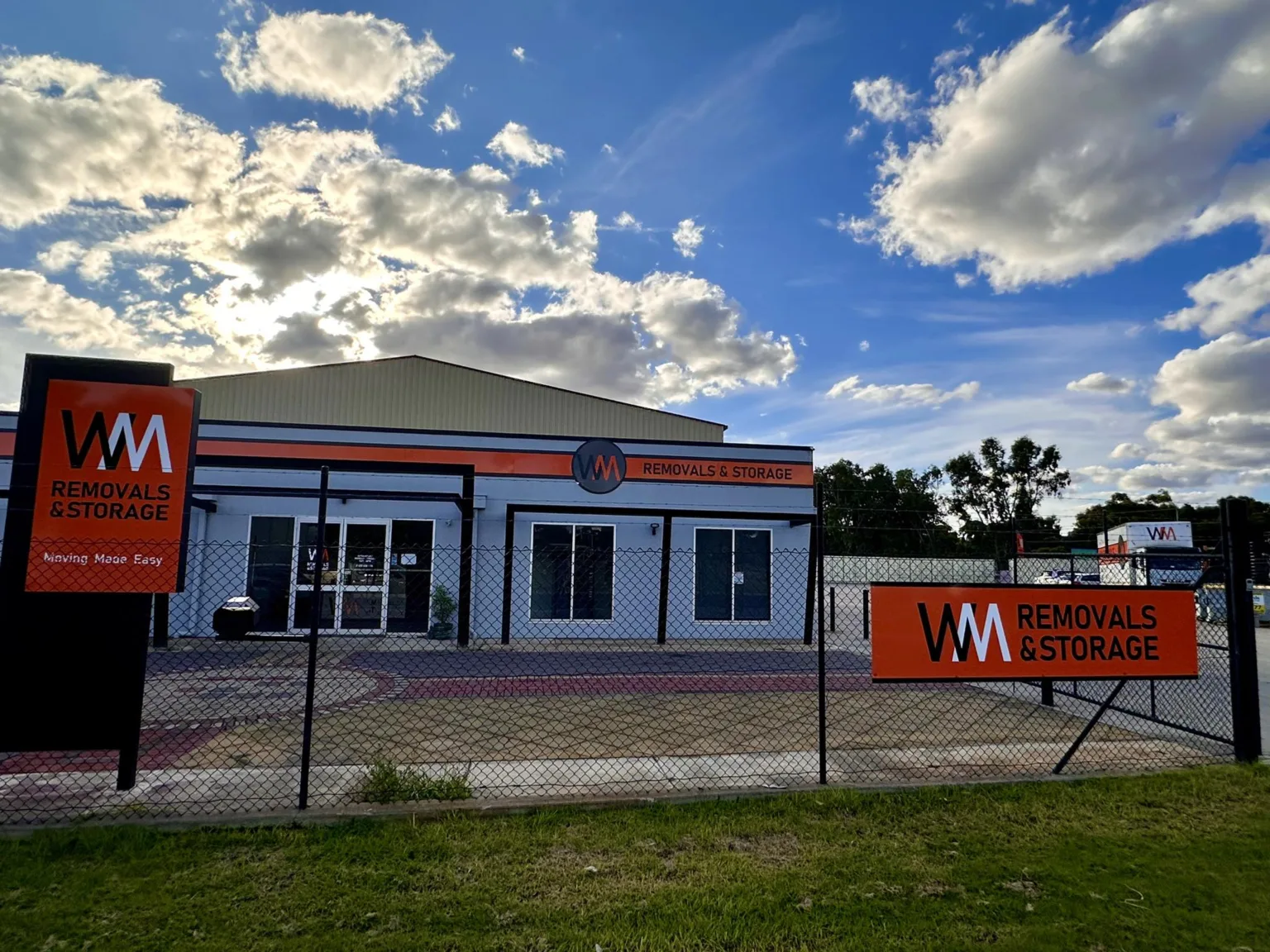 WM Removals & Storage warehouse signage showcasing furniture removal and storage services.